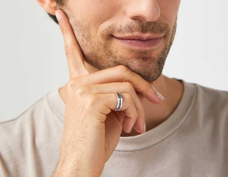 The Outer Wave Ring in Antiqued Sterling Silver on a male